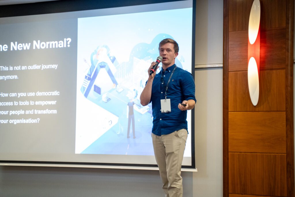 A speaker presenting with a handheld microphone