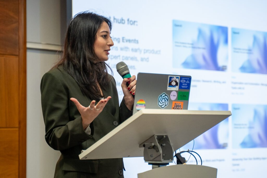 A speaker at the lectern mid-talk