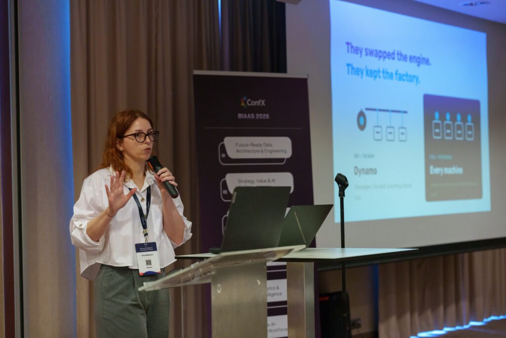 A speaker presenting at the lectern
