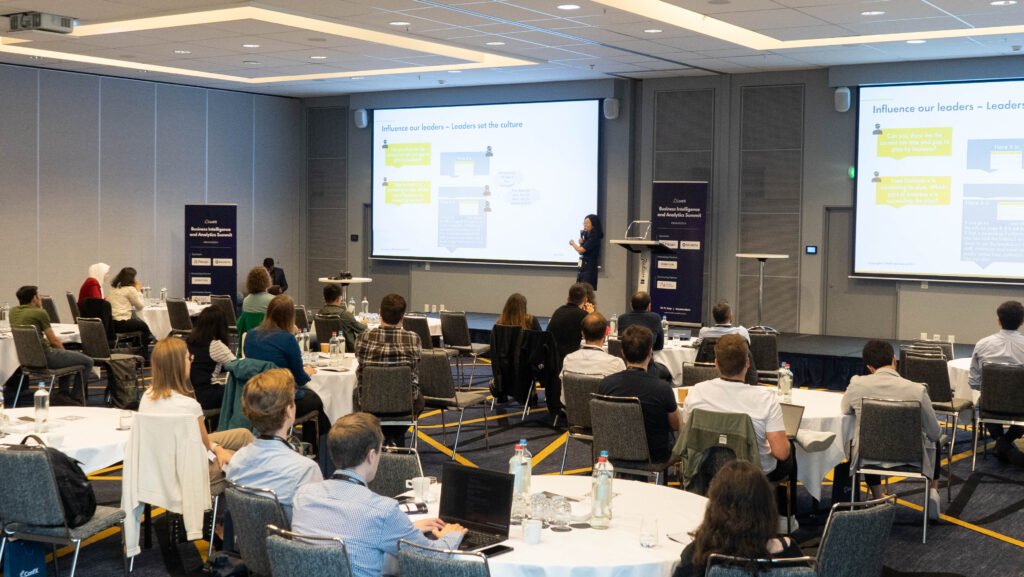 A full session room with two screens