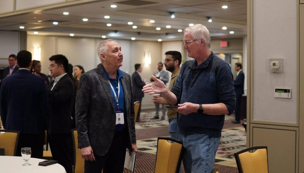 Two delegates in conversation during a networking break