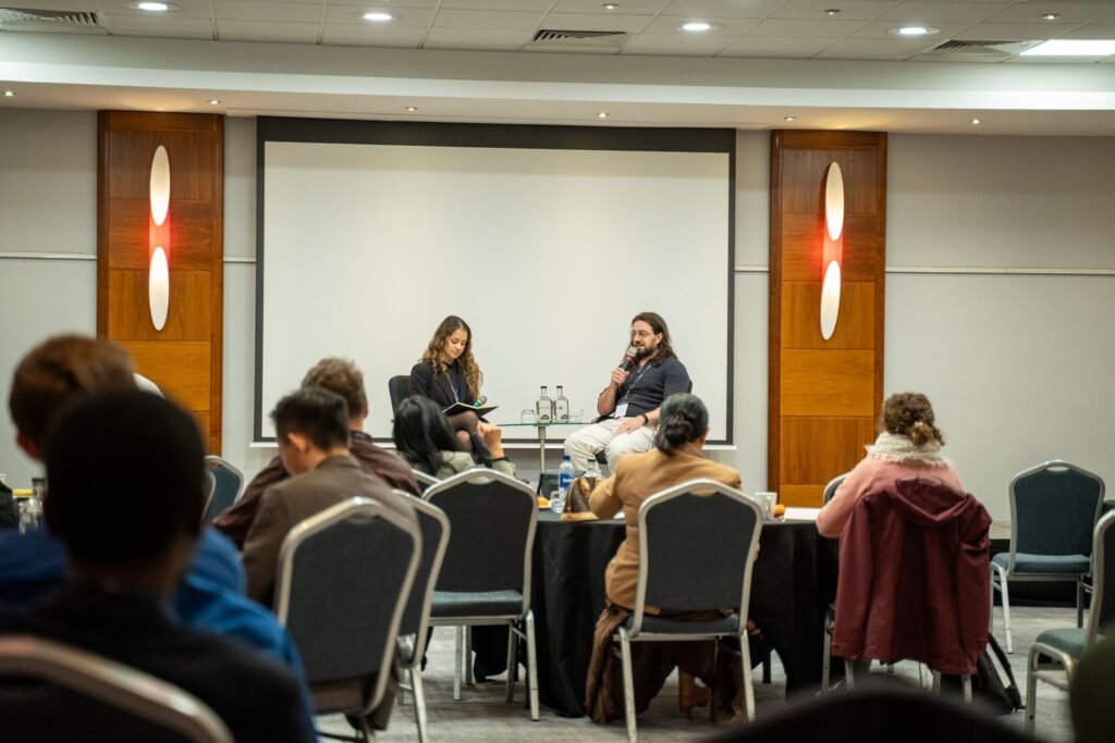 A panel discussion on stage in front of the audience