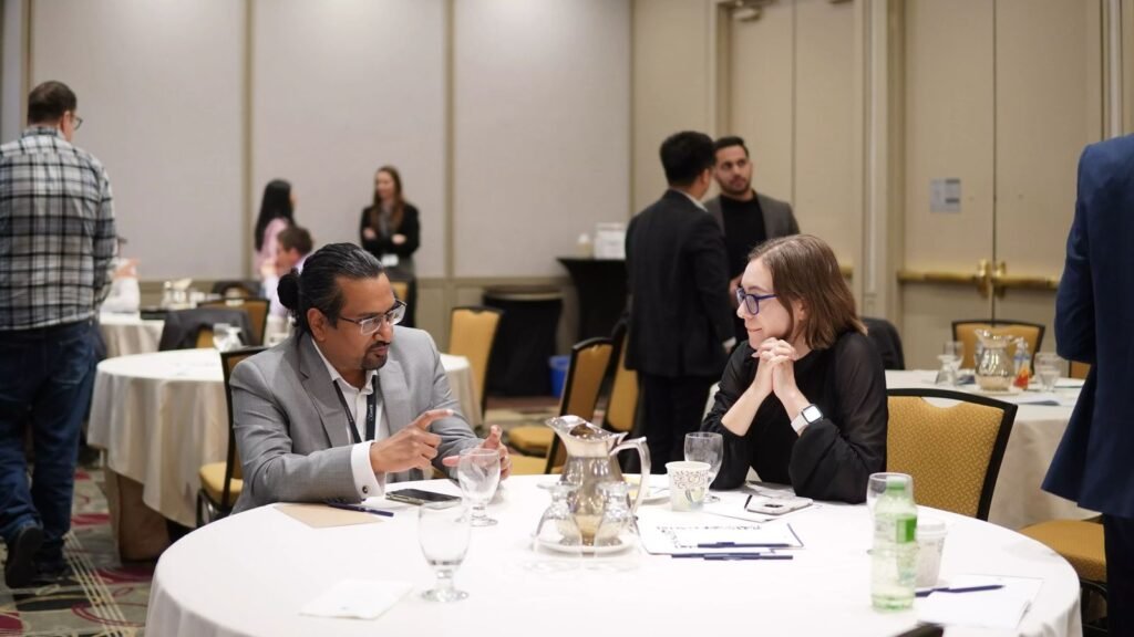 Two delegates in a one-to-one meeting at a round table