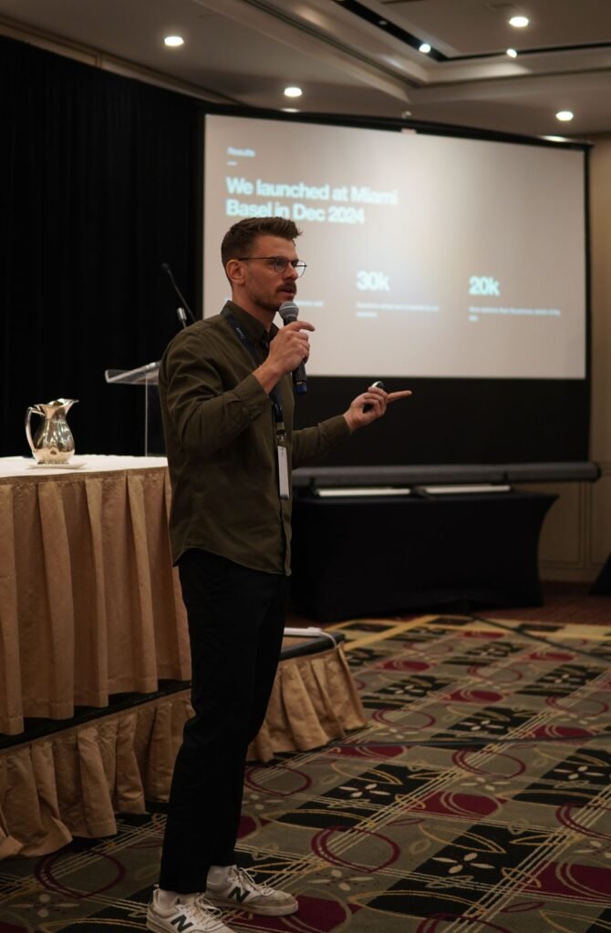A speaker presenting on stage at a previous BIAAS summit